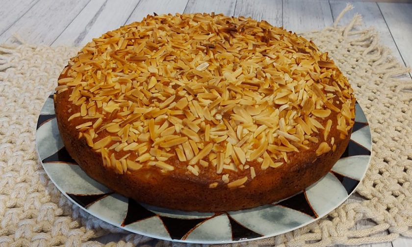 Buttery Almond Madeira Cake with a Crunchy Top fresh from the oven and ready on a plate to cut and enjoy.