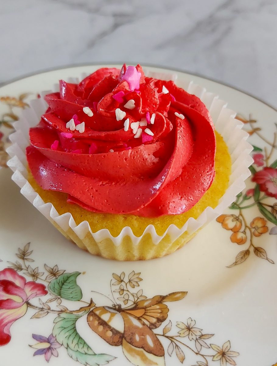 One beautifully frosted cupcake with sprinkles, placed on a delicate vintage plate, adding a touch of elegance to your treat.