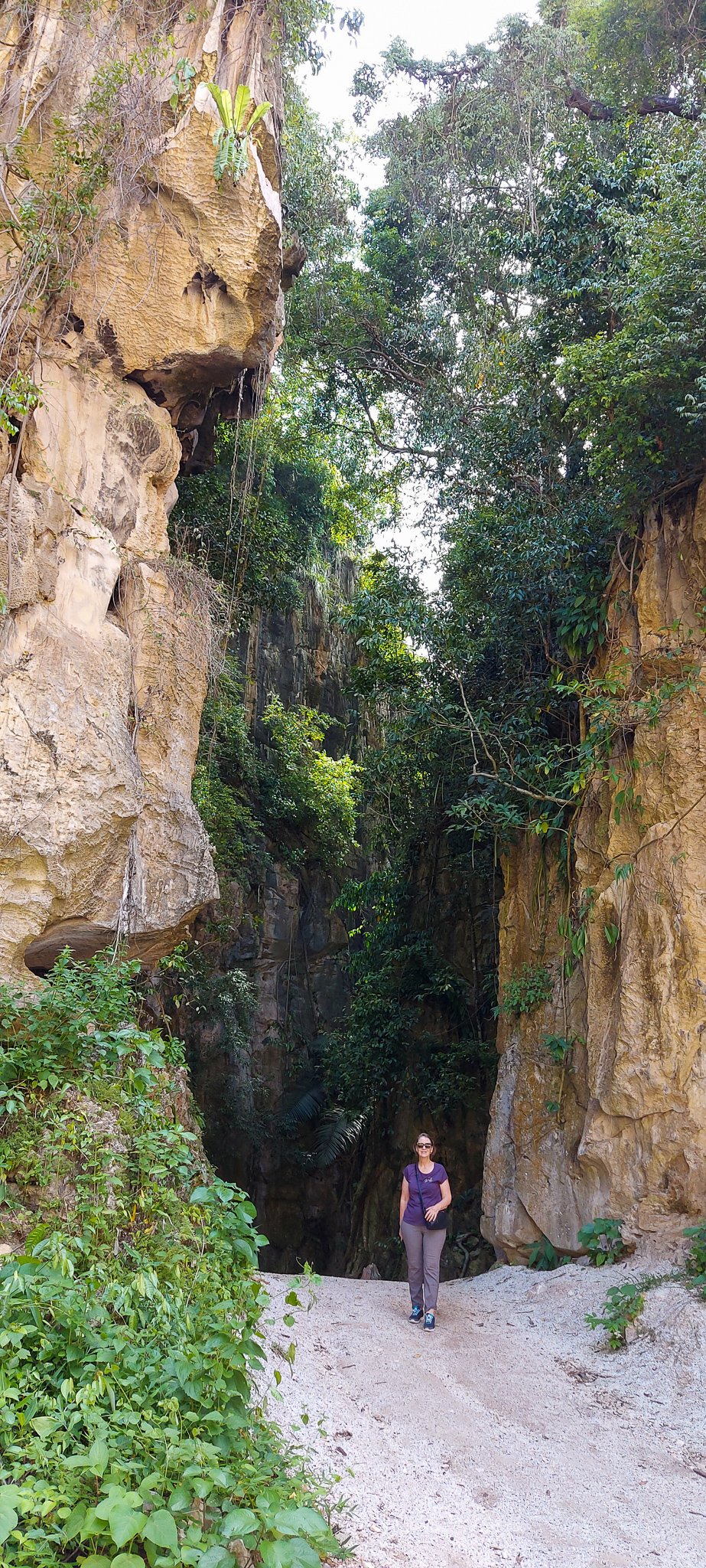 Woman in front of towering limestone cliffs