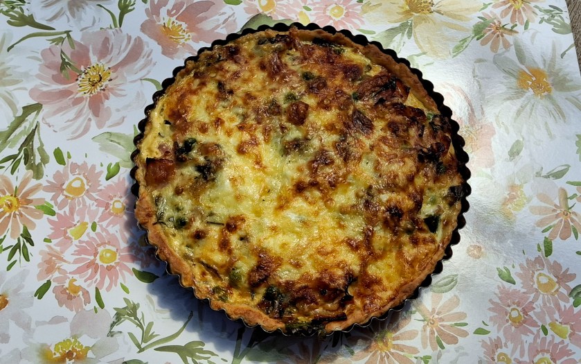 A golden bacon and egg pie still warm in the baking tin.