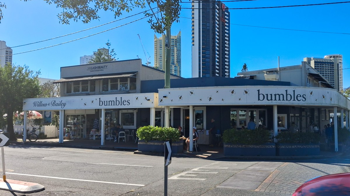 Exterior view of Bumbles Café on the Gold Coast, Australia, showcasing the building's signage and surrounding streetscape.